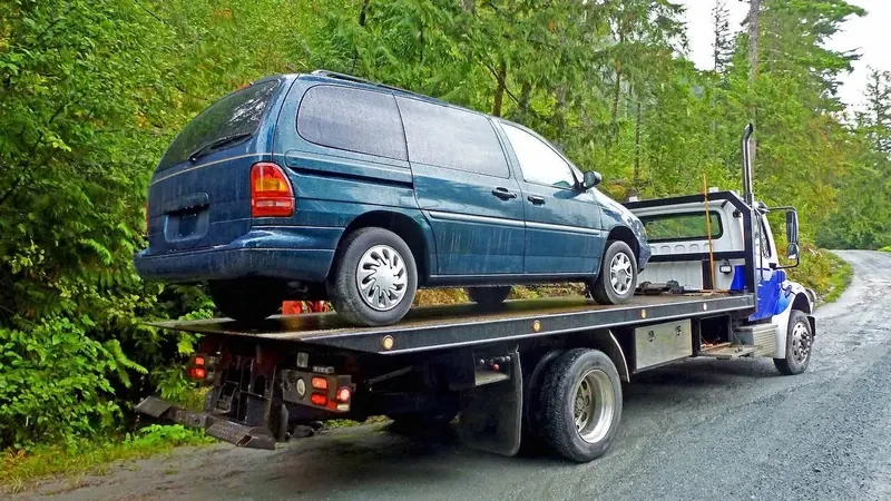 st. Louis flatbed towing a cargo van