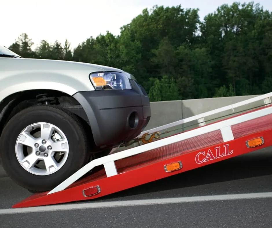 st. Louis tow truck loading a vehicle on a residential street